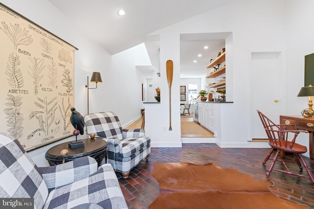 sitting room featuring baseboards, recessed lighting, and vaulted ceiling