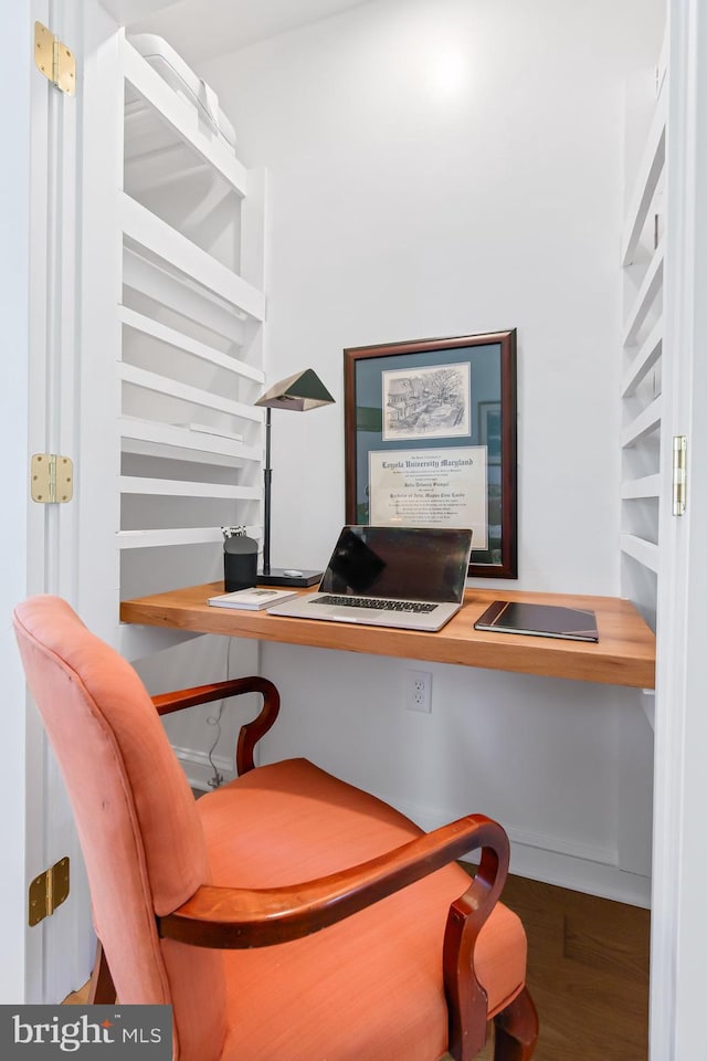 office space featuring built in desk and wood finished floors