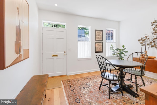 dining room with wood finished floors, baseboards, and recessed lighting