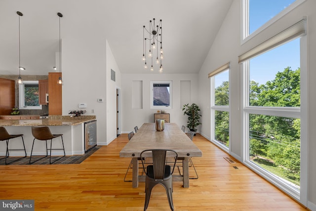 2621 S Arlington Ridge Rd, Arlington, VA 22202 - dining space featuring high vaulted ceiling, light wood-style flooring, beverage cooler, and visible vents