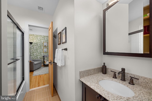 bathroom featuring an enclosed shower, tile patterned floors, visible vents, and vanity