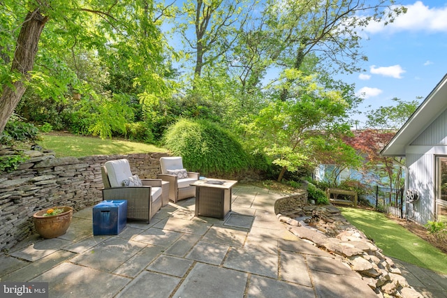 view of patio with a fire pit and fence