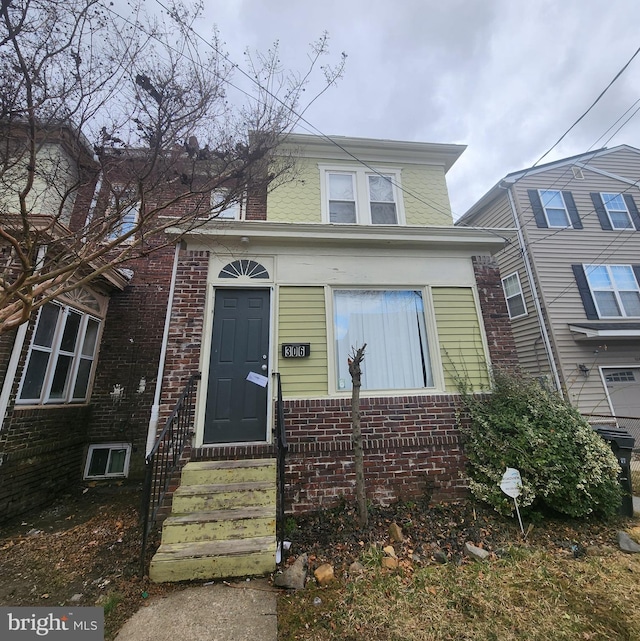 view of front of property featuring brick siding and entry steps
