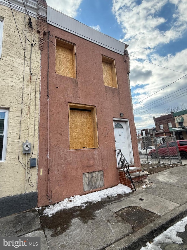 3243 Joyce St, Philadelphia, PA 19134 - view of front of property with stucco siding and fence