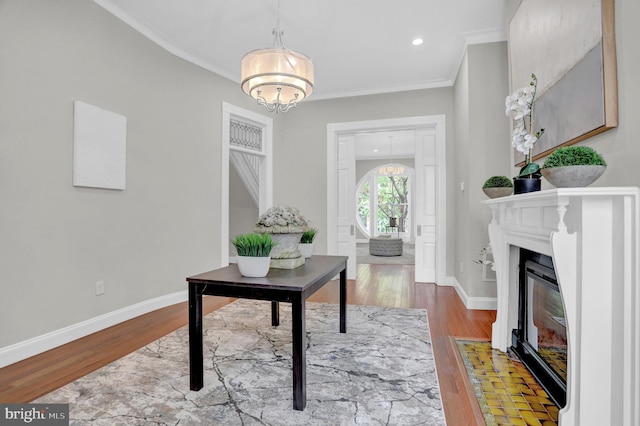 office space with recessed lighting, wood finished floors, a chandelier, ornamental molding, and baseboards