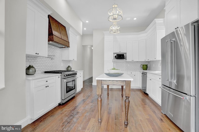kitchen with light countertops, backsplash, high end appliances, and custom exhaust hood
