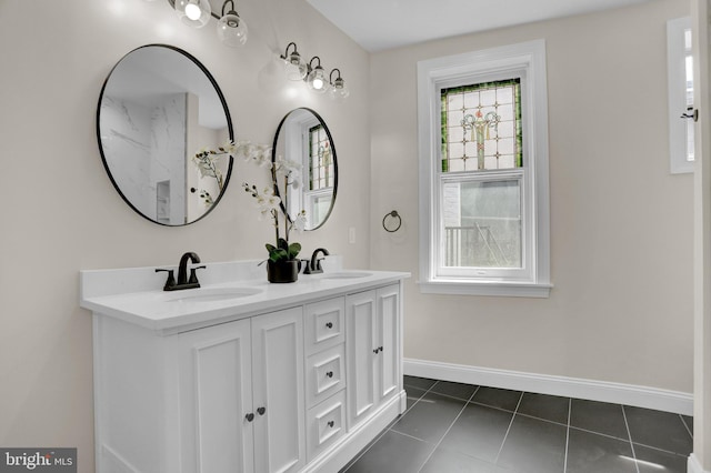 full bathroom with tile patterned floors, baseboards, double vanity, and a sink
