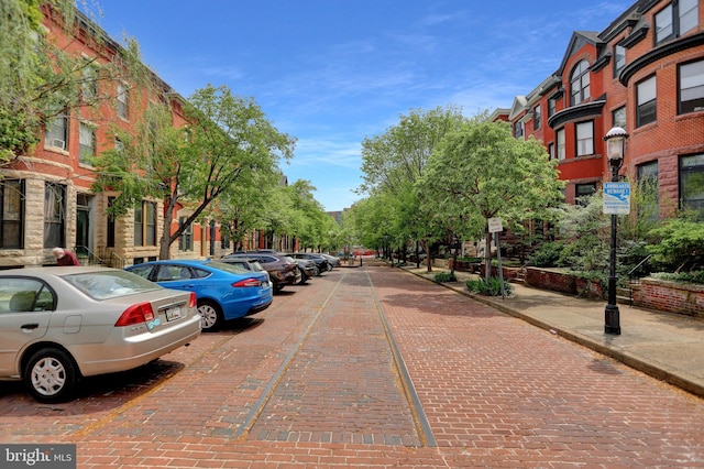 view of road featuring sidewalks, curbs, and street lighting