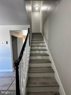 staircase featuring baseboards