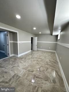 basement featuring baseboards and recessed lighting