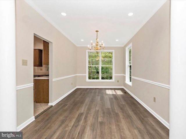 unfurnished dining area featuring baseboards, crown molding, a chandelier, and dark wood-style floors