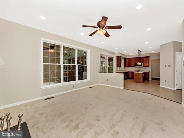 unfurnished living room featuring light carpet and recessed lighting