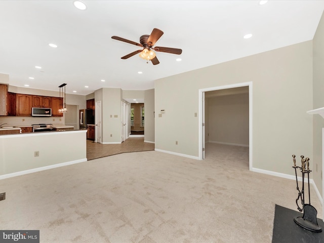 unfurnished living room featuring light colored carpet, baseboards, a ceiling fan, and recessed lighting