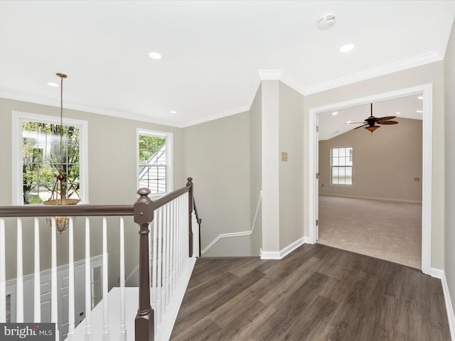 hallway with dark wood-style flooring, an upstairs landing, baseboards, ornamental molding, and recessed lighting