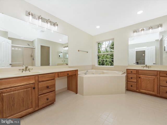 full bathroom featuring a shower stall, a garden tub, tile patterned flooring, and a sink