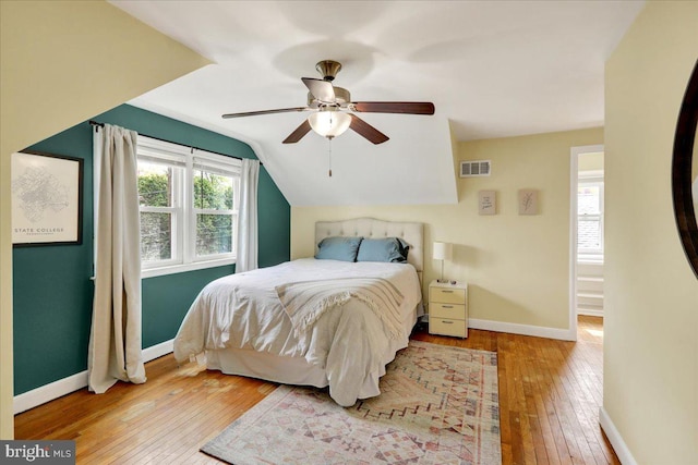 bedroom featuring wood-type flooring, baseboards, ceiling fan, and vaulted ceiling