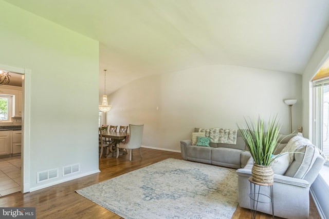 76 Briarwood Dr E, Berkeley Heights, NJ 07922 - living room with a chandelier, lofted ceiling, healthy amount of natural light, wood finished floors, and baseboards