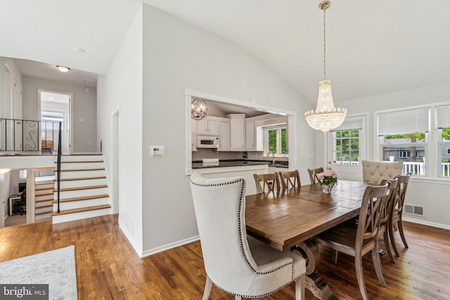 76 Briarwood Dr E, Berkeley Heights, NJ 07922 - dining room with a chandelier, wood finished floors, lofted ceiling, stairs, and baseboards