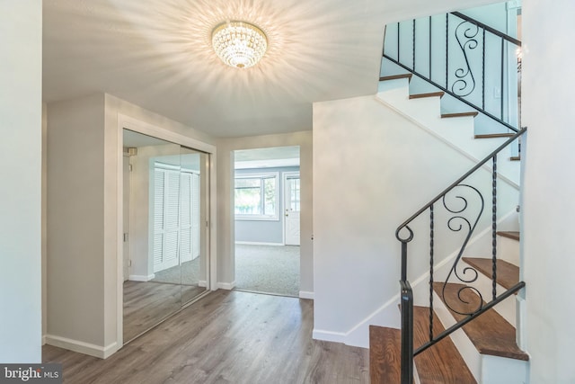 76 Briarwood Dr E, Berkeley Heights, NJ 07922 - staircase featuring a chandelier, baseboards, and wood finished floors