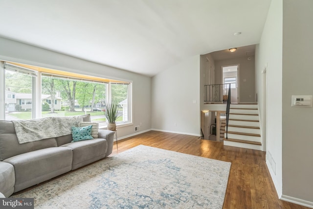 76 Briarwood Dr E, Berkeley Heights, NJ 07922 - living room featuring wood finished floors, baseboards, stairway, and lofted ceiling