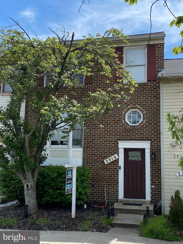 view of property with brick siding