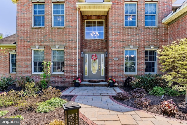 property entrance with brick siding