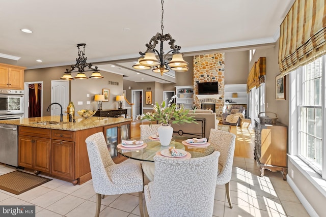 dining space featuring light tile patterned flooring, a chandelier, plenty of natural light, and visible vents