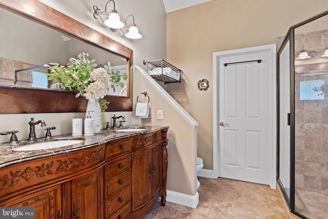 bathroom featuring double vanity, a shower stall, and a sink