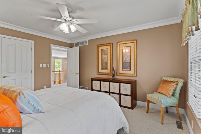 carpeted bedroom featuring visible vents, ornamental molding, baseboards, and ceiling fan