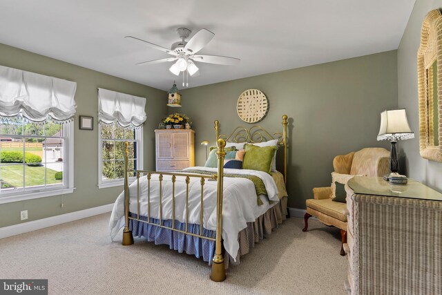 bedroom with carpet floors, a ceiling fan, and baseboards