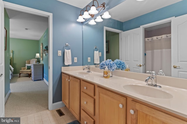 full bath featuring a sink, baseboards, double vanity, and visible vents