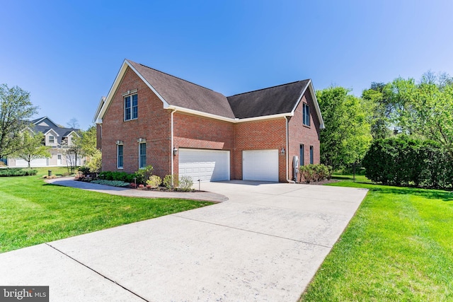 view of side of property featuring brick siding, a garage, a lawn, and concrete driveway