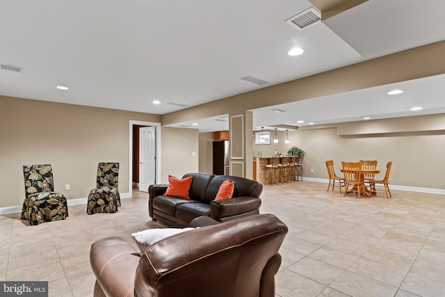 living room featuring indoor bar, recessed lighting, visible vents, and light tile patterned floors