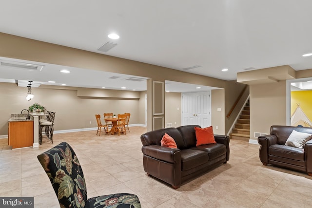 living area with recessed lighting, baseboards, light tile patterned floors, visible vents, and stairway