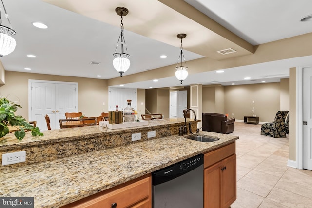 kitchen featuring a sink, open floor plan, stainless steel dishwasher, visible vents, and pendant lighting