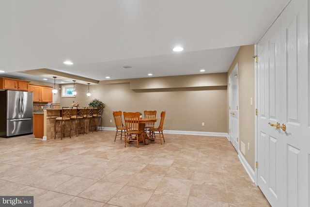 dining area featuring indoor bar, recessed lighting, baseboards, and visible vents