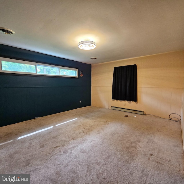 carpeted spare room with a baseboard radiator