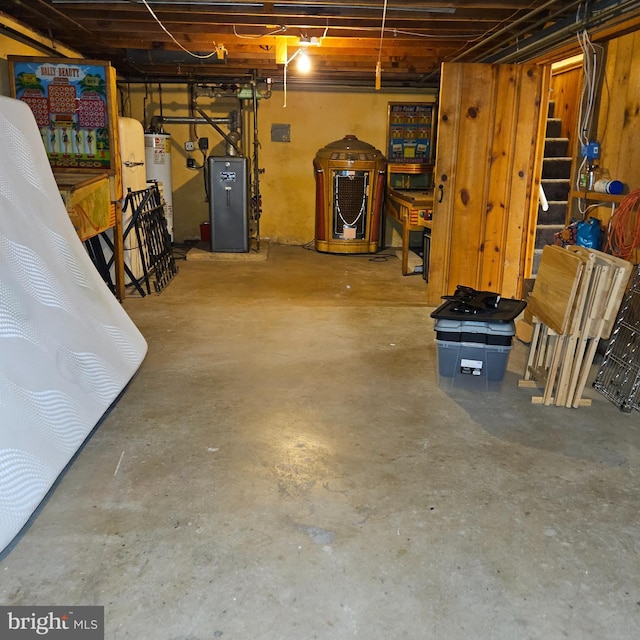 unfinished basement featuring gas water heater, stairway, and a heating unit