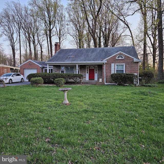 single story home featuring a chimney, a front yard, brick siding, and a garage