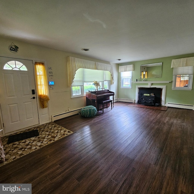 entryway with wood finished floors, plenty of natural light, and baseboard heating