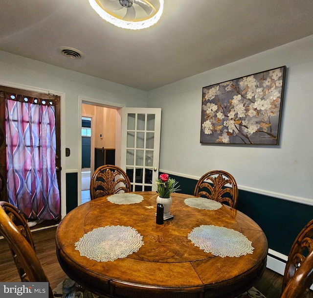 dining room featuring wood finished floors and a baseboard heating unit