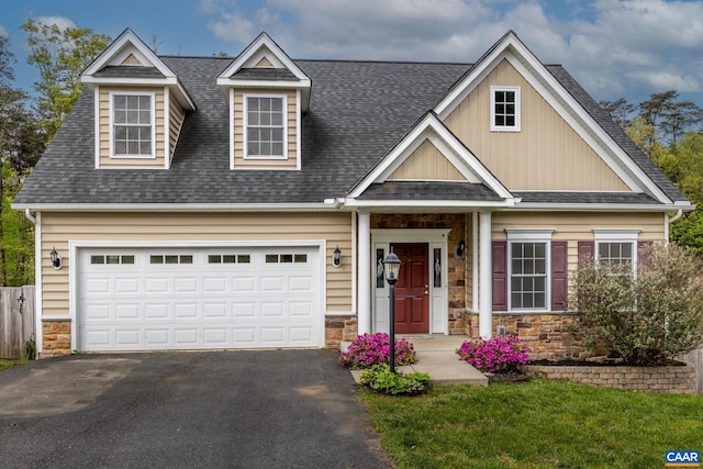 6348 Flintstone Dr, Barboursville, VA 22923 - view of front facade with board and batten siding, driveway, a shingled roof, and stone siding