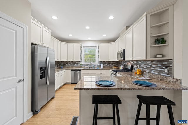 6348 Flintstone Dr, Barboursville, VA 22923 - kitchen with open shelves, a peninsula, a sink, appliances with stainless steel finishes, and backsplash