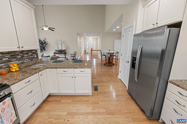 6348 Flintstone Dr, Barboursville, VA 22923 - kitchen featuring high vaulted ceiling, stainless steel appliances, a peninsula, and white cabinetry