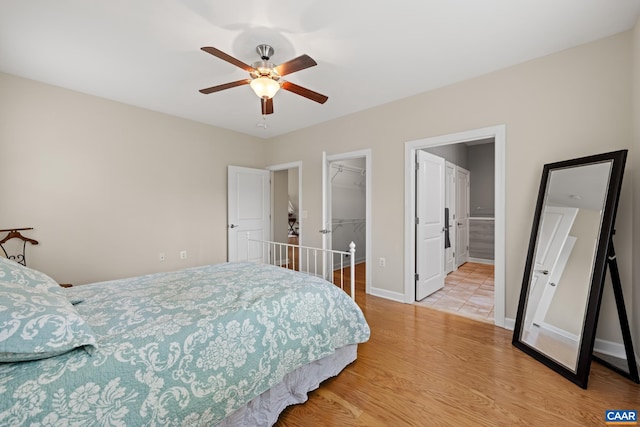 6348 Flintstone Dr, Barboursville, VA 22923 - bedroom featuring a closet, wood finished floors, baseboards, a walk in closet, and a ceiling fan