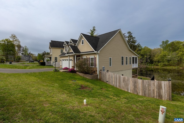 6348 Flintstone Dr, Barboursville, VA 22923 - view of side of home featuring a garage, fence, a yard, and aphalt driveway