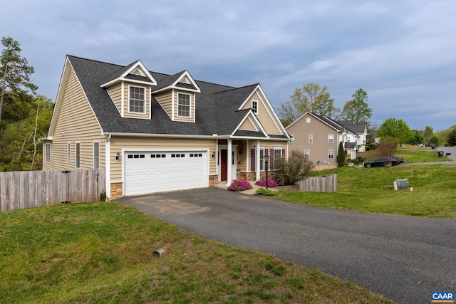 6348 Flintstone Dr, Barboursville, VA 22923 - view of front facade with a front yard, fence, aphalt driveway, a shingled roof, and stone siding