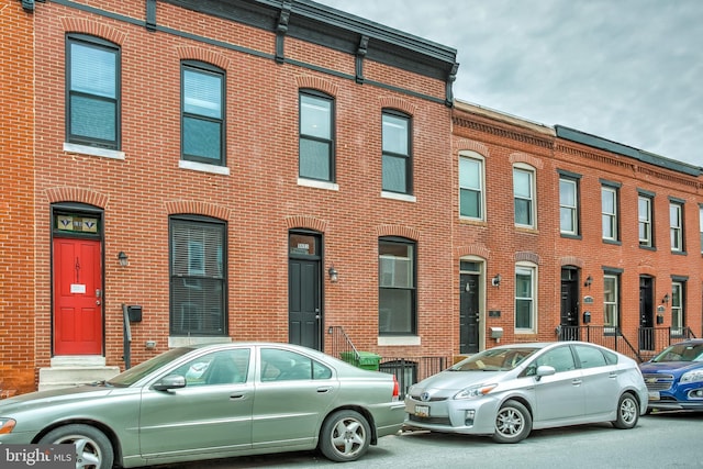 view of property featuring brick siding