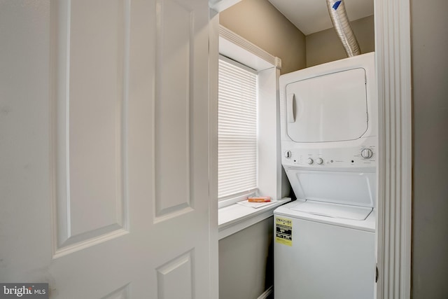 laundry room featuring stacked washer / drying machine