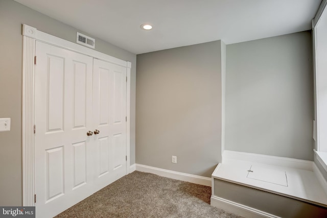 unfurnished bedroom featuring a closet, recessed lighting, baseboards, carpet flooring, and visible vents